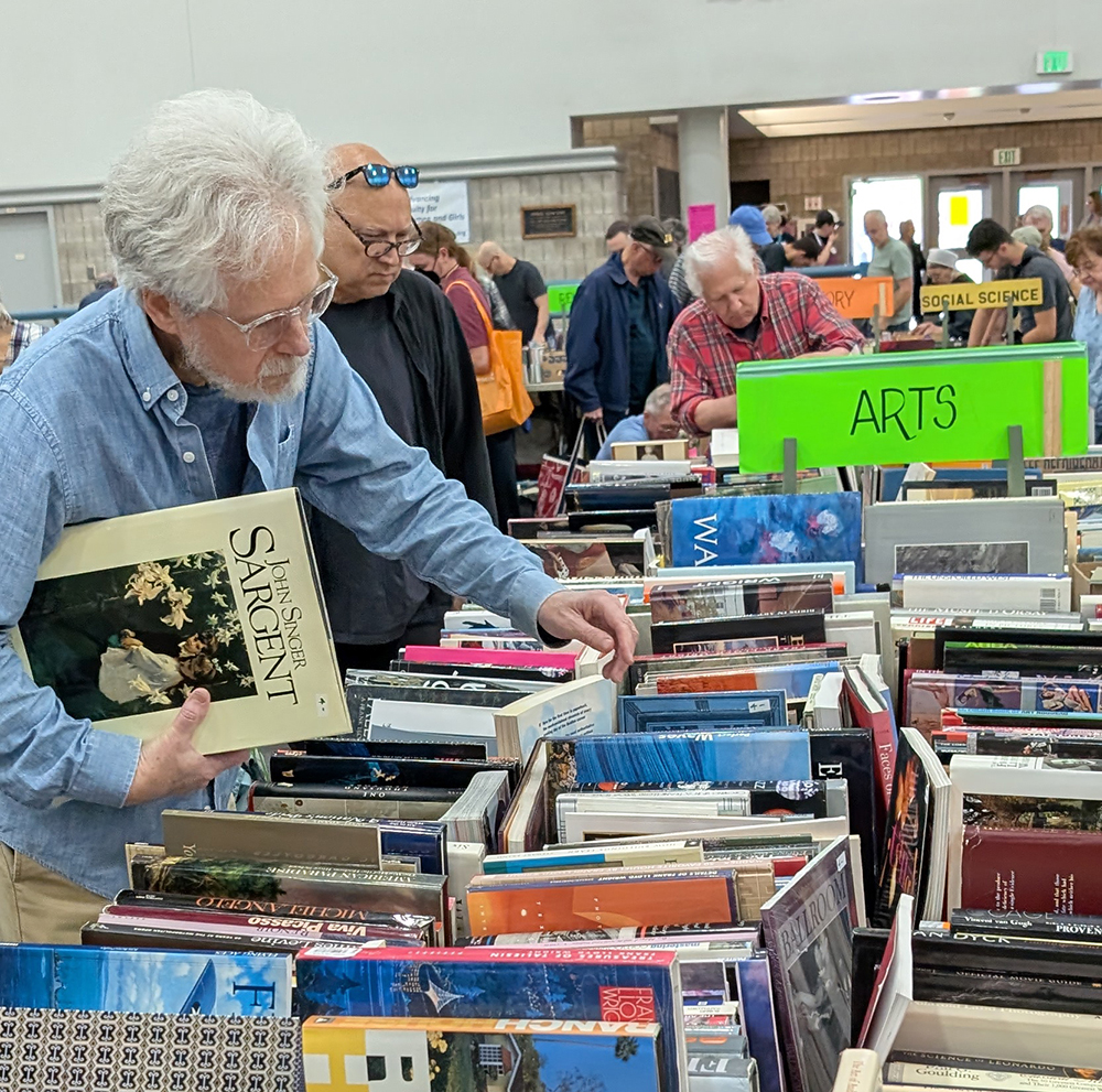 Shoppers check out the selection of Art books at the 2025 Used Book Sale