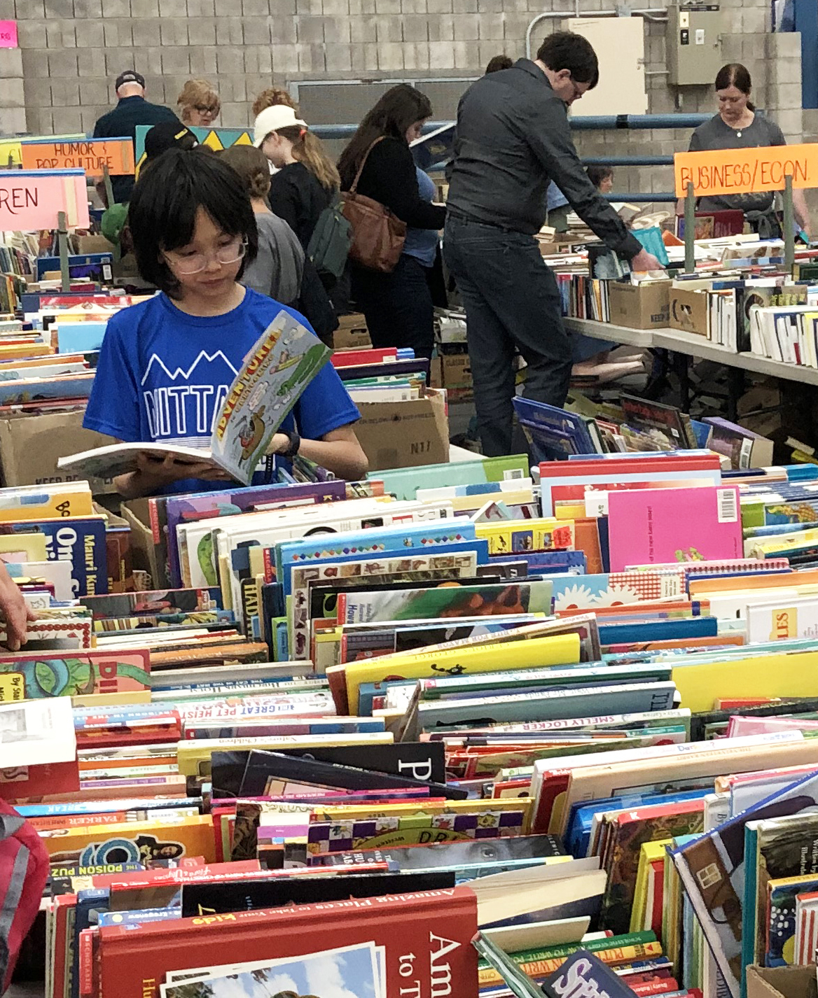 Child reading at AAUW Used Book Sale