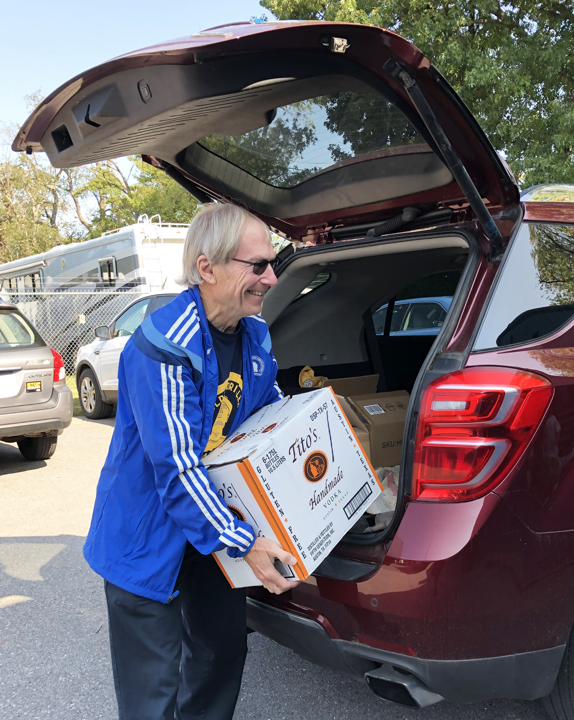 A volunteer unloads a box of donated books at the Book Workshop