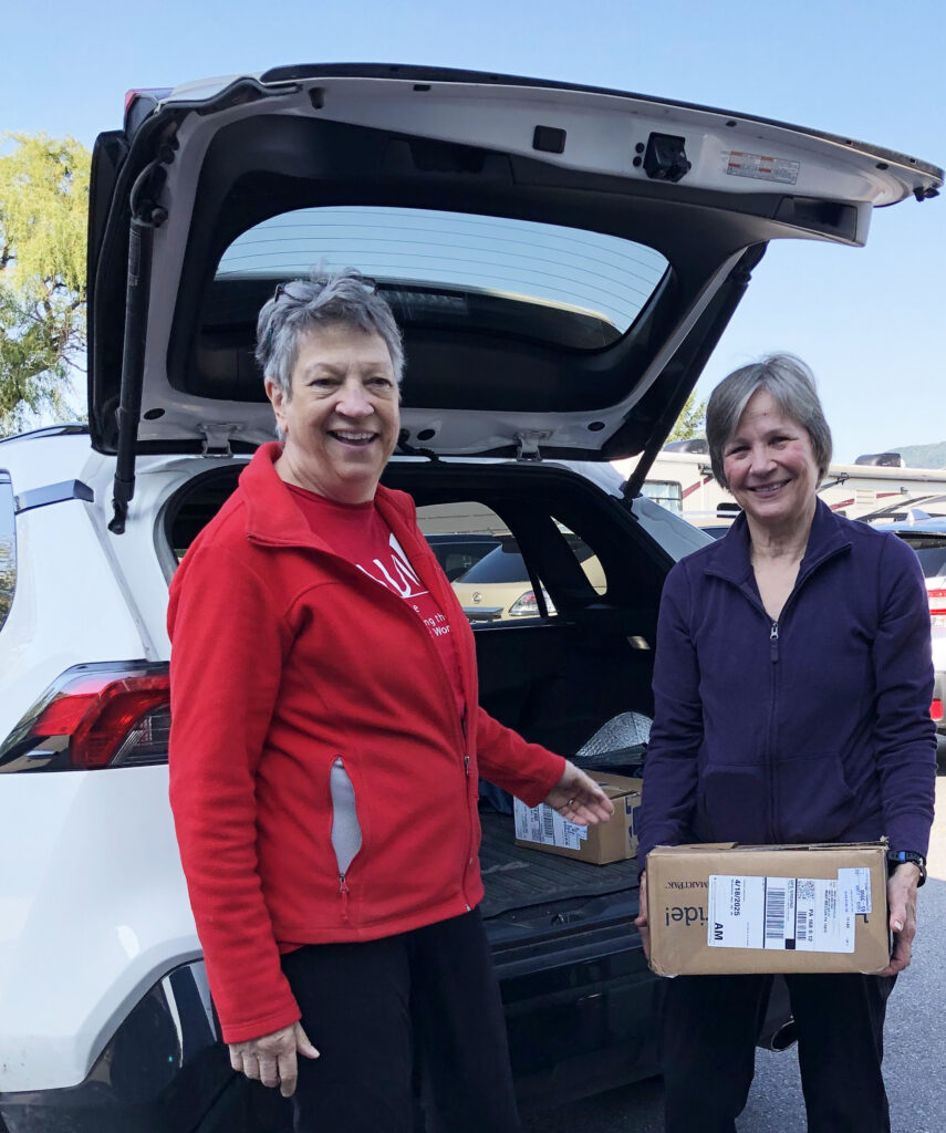 Mary Ann Blair greeting a book donor