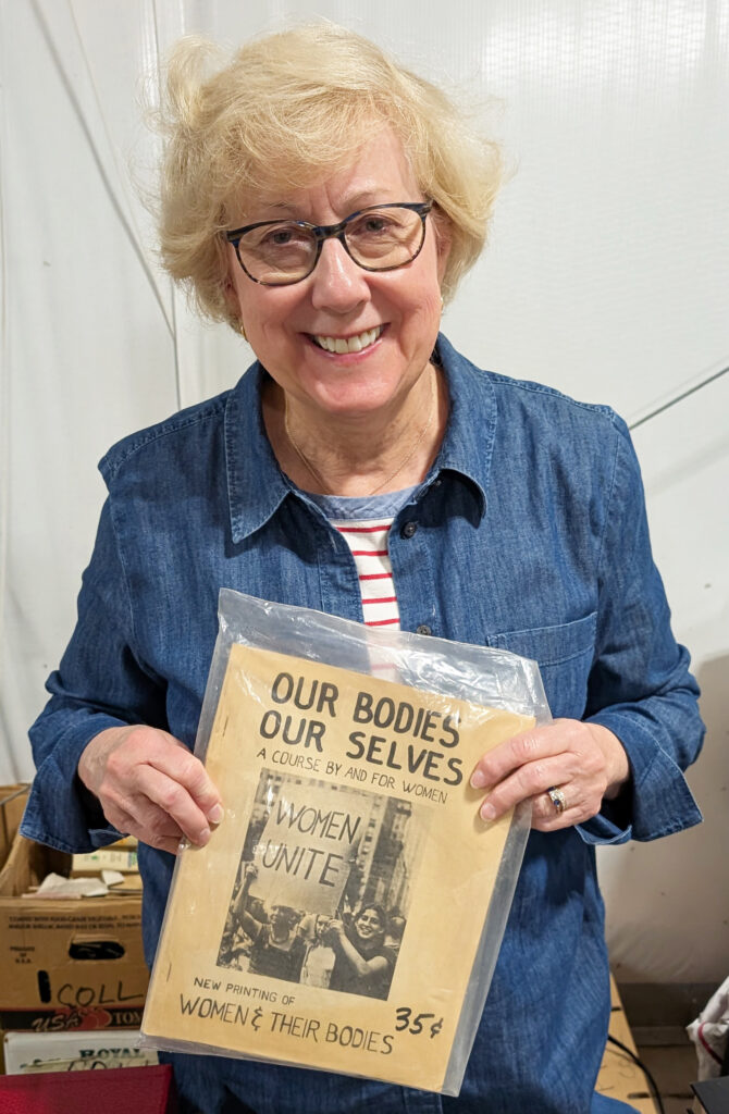 Sally Kalin with a copy of Our Bodies Ourselves